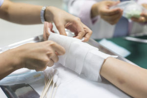 nurse dresses wounds of burn victim