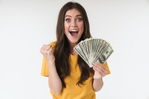 excited woman holding money