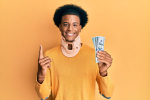 man in neck brace excited to have money for his injury