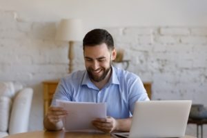 man happy to see he qualifies for car accident loan