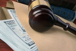 gavel sits on cash meant for legal fees