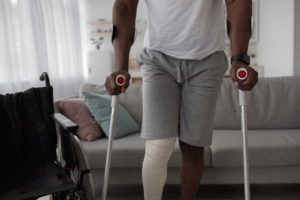black man on crutches
