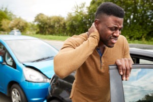 car accident victim holding his neck