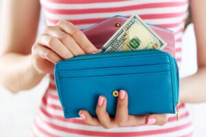woman taking cash out of her purse