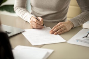 woman filling out loan paperwork