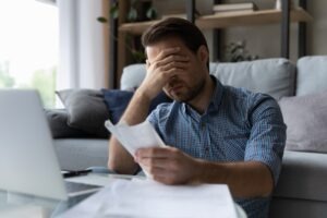 stressed man reviewing his bills